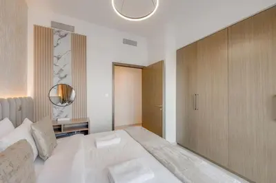 a bedroom with a large white bed and a mirror at Luxury 2 bed, 5 mins walk to Dubai Mall and Burj Khalifa in Dubai