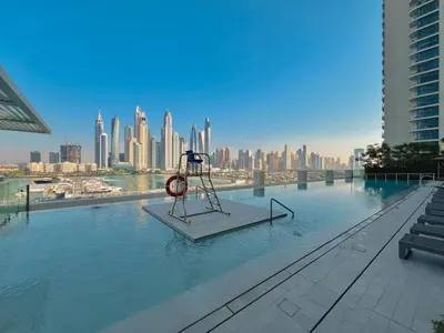 a swimming pool with a playground in the middle of a city at Waves - Beachfront Bliss - Marina Vista 1BR Escape in Dubai