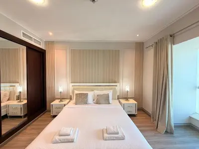 a bedroom with a large bed with two pillows on it at Panoramic Fireworks Views with Palm Jumeirah Bluewaters and Ain dubai View in Dubai