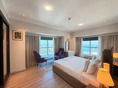 a hotel room with a large bed and windows at Panoramic Fireworks Views with Palm Jumeirah Bluewaters and Ain dubai View in Dubai