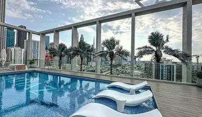 a swimming pool on the roof of a building at Stylish new apartment with Burj and Downtown views in Dubai