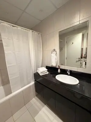 a bathroom with a sink and a mirror at Cove Luxe Holiday Home JVC in Dubai