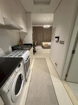 a kitchen with a stove and a washer at Cove Luxe Holiday Home JVC in Dubai