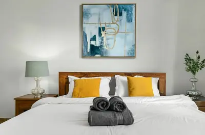 a bedroom with two towels on a bed at Modern 1BR Apartment - Burj Khalifa View - Pool & Terrace - Near Metro in Dubai