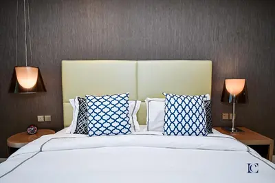 a bedroom with a large bed with blue and white pillows at Luxury Escapes Premium 1BR - Paramount Tower Business Bay in Dubai