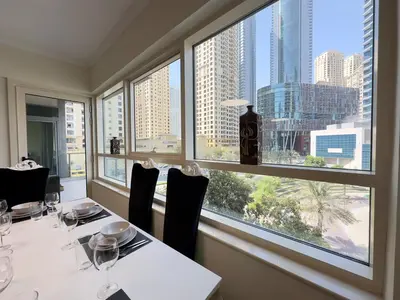 a dining room with a view of the city at Charming 2BR in Dubai Marina with Lake View in Dubai