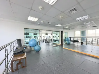 a gym with pilates equipment in a large room at Charming 2BR in Dubai Marina with Lake View in Dubai
