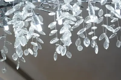 a chandelier with crystals hanging from a ceiling at Luxury 2BR in Mada Residences - Walk to Dubai Mall in Dubai