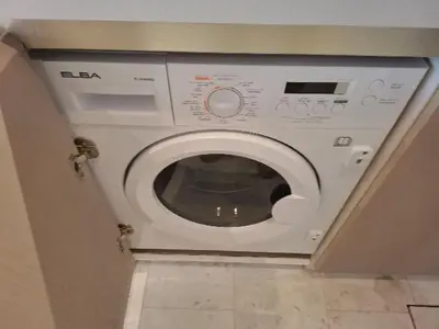 a white washer and dryer in a bathroom at Luxury 1BR in The Palm Tower Near Nakheel Mall in Dubai