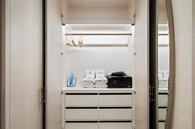 a walk in closet with a mirror and towels at Luxury 1BR in The Palm Tower Near Nakheel Mall in Dubai