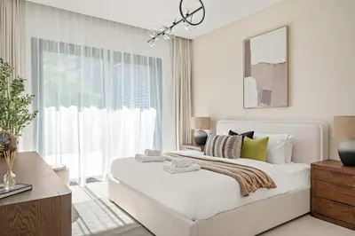 a white bedroom with a large bed and a window at Silkhaus Luxury New Tower in City Walk in Dubai