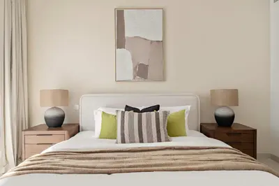 a bedroom with a white bed with two night stands at Silkhaus Luxury New Tower in City Walk in Dubai