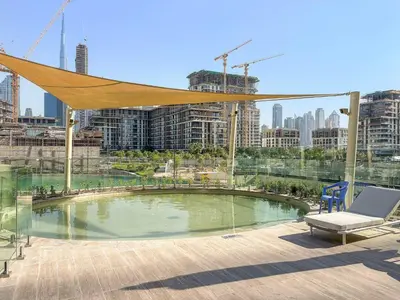 a pool with a canopy and a chair in a city at Silkhaus Luxury New Tower in City Walk in Dubai