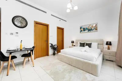 a bedroom with a bed and a table and a desk at Urban apartment near to Dubai mall & Burj Khalifa in Dubai
