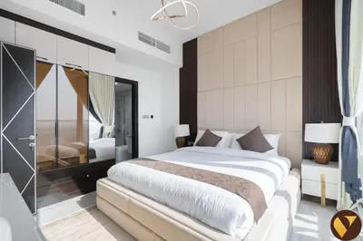 a bedroom with a large white bed and a mirror at Vogue Al Furjan Gemz by Danube near Ibn Battuta Mall, Three Bedroom plus Kids room Apartment with Balcony and Private Pool, Access to all amenities in Dubai