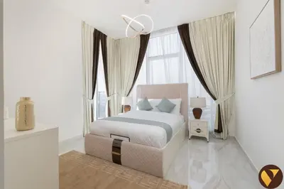 a bedroom with a bed and a large window at Vogue Al Furjan Gemz by Danube near Ibn Battuta Mall, Three Bedroom plus Kids room Apartment with Balcony and Private Pool, Access to all amenities in Dubai