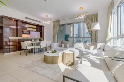a living room with a white couch and a table at Burj Khalifa View - 2 Bedroom apartment at The Residence 5, Downtown - Allsopp & Allsopp in Dubai