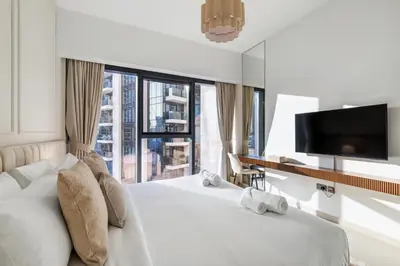 a hotel room with a bed and a large window at Blissful Stays - Luxury Two Bedroom Apartment at ACT Tower 2, Boulevard, Burj Khalifa, Pool, Near Dubai Mall in Dubai