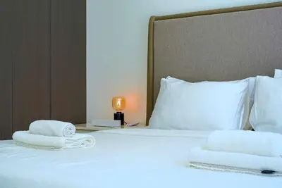 a bed with two towels on top of it at TRPS - District One Residences, MBR - Brand New 3BR plus Maids, Lagoon View, Fully Furnished in Dubai
