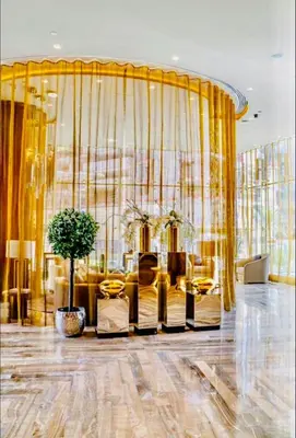 a living room with yellow curtains and a couch at Luxury Fendi with Stunning Marina Views in Dubai