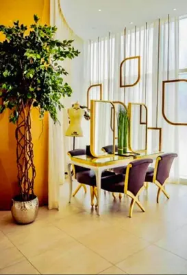 a room with a table with mirrors and a plant at Luxury Fendi with Stunning Marina Views in Dubai