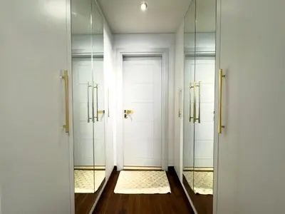 a walk in shower with two doors and mirrors at Luxury Fendi with Stunning Marina Views in Dubai