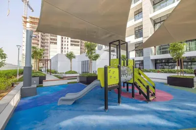 a playground with a slide in a building at Bright Studio with Pool Access - Azizi Riviera in Dubai