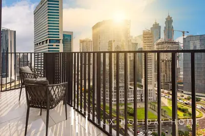 a chair on a balcony with a city skyline at LUX The Business Bay Executive Suite in Dubai