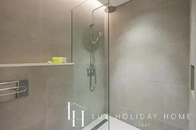 a shower with a glass door in a bathroom at LUX The Business Bay Executive Suite in Dubai