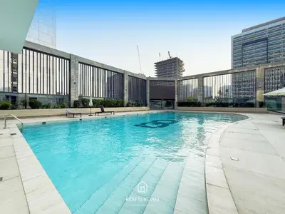 a large swimming pool on top of a building at Brand New 1B with Burj Khalifa View in Business Bay in Dubai