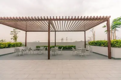 a wooden pavilion with tables and chairs on a patio at Peaceful and Cozy Studio, Burj Khalifa View in Dubai