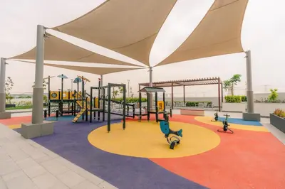 a playground with slides and swings in a play area at Peaceful and Cozy Studio, Burj Khalifa View in Dubai