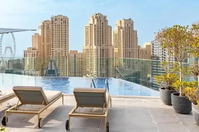 two chairs on a balcony with a view of a city at Vogue Marina, Condor Marina Star near Ain Dubai and JBR Beach, One Bedroom Apartment with Balcony and City View, Access to all Amenities in Dubai