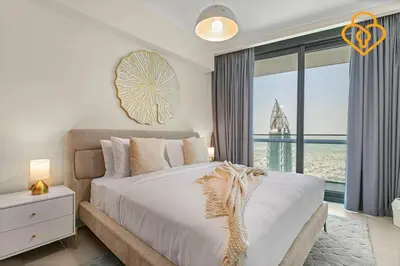 a bedroom with a large bed and a large window at Seaview 3 BR Burj Vista Connected to Dubai Mall in Dubai
