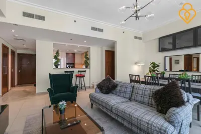 a living room with a couch and a table at Seaview 3 BR Burj Vista Connected to Dubai Mall in Dubai