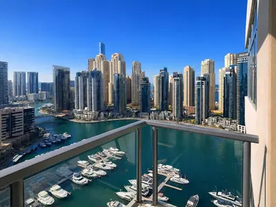 a balcony with a view of a harbor with boats at Dream Shoma - 2R Serene Apt Direct Marina access in Dubai