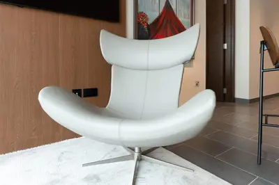 a white chair sitting in a room at Luxury 1BR Retreat near DIFC & Downtown Dubai in Dubai