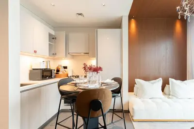 a kitchen and dining room with a table and chairs at Luxury 1BR Retreat near DIFC & Downtown Dubai in Dubai