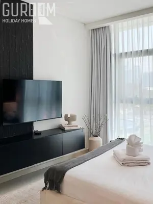 a bedroom with a flat screen tv and a bed at Great Cozy Studio on Palm Jumeirah in Dubai