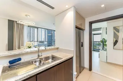 a kitchen with a sink and a large window at PVH - Creek Residences South T3 - Harbourfront 2BR in Dubai