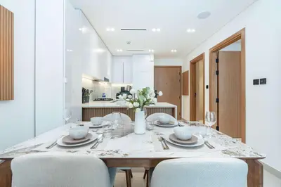 a dining room with a table and chairs at PVH - Pristine 1BR Minutes to Circle Mall - Binghatti Amber in Dubai