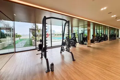 a gym with treadmills and cardio equipment in a building at PVH - Pristine 1BR Minutes to Circle Mall - Binghatti Amber in Dubai