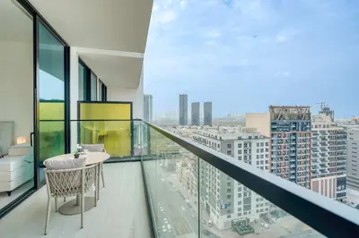 a balcony with a table and a view of a city at PVH - Pristine 1BR Minutes to Circle Mall - Binghatti Amber in Dubai