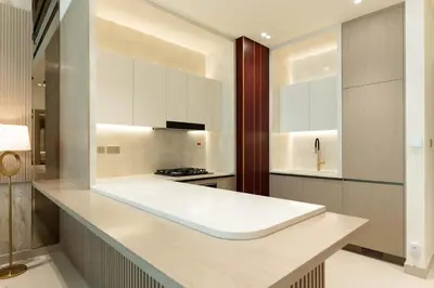 a kitchen with white cabinets and a counter top at Luxury 1BR Apartment with Private Pool & Gym Access in Dubai