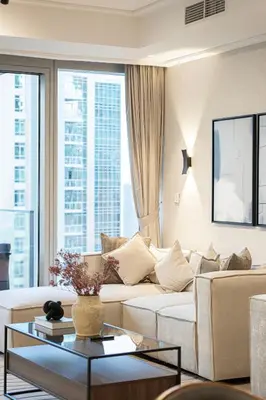 a living room with a couch and a table at 4BR Penthouse Feel Featuring Stunning Burj And Fountain View in Dubai