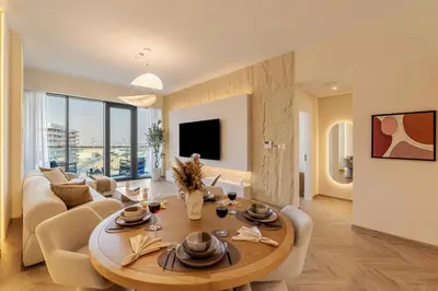 a living room with a table and a couch at Canal Stays in Dubai