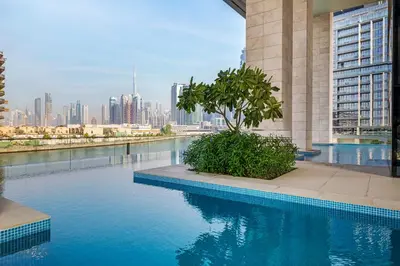 a swimming pool with a city skyline in the background at Canal Stays in Dubai