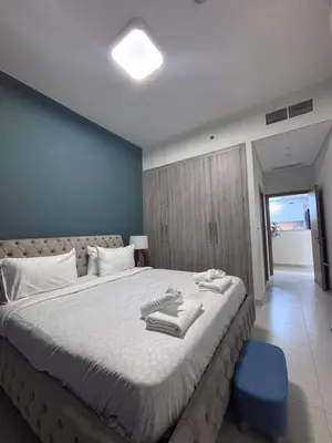 a bedroom with a large bed with towels on it at High-Floor 1BR Escape - The Bay Rooftop Pool in Dubai