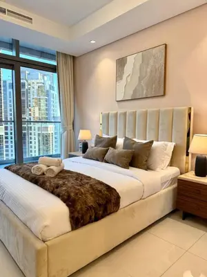 a bedroom with a large bed with a large window at Luxury 2BR, Burj Khalifa View, Fully equipped, Top Amenities in Dubai