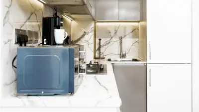 a bathroom with a blue urinal and a sink at Azizi Riviera 1, Meydan Close to Downtown - Onelink in Dubai